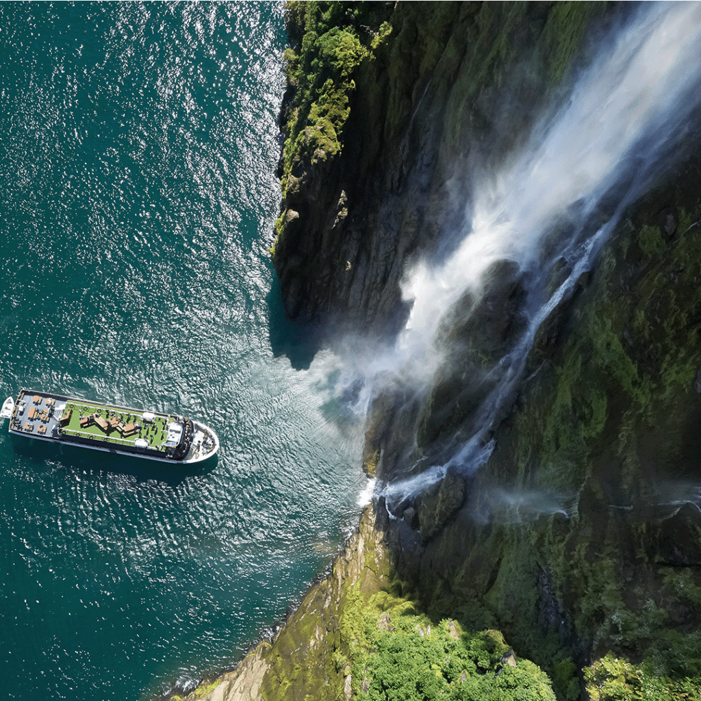 Milford Sound Coach and Cruise glass-roof coach on scenic highway