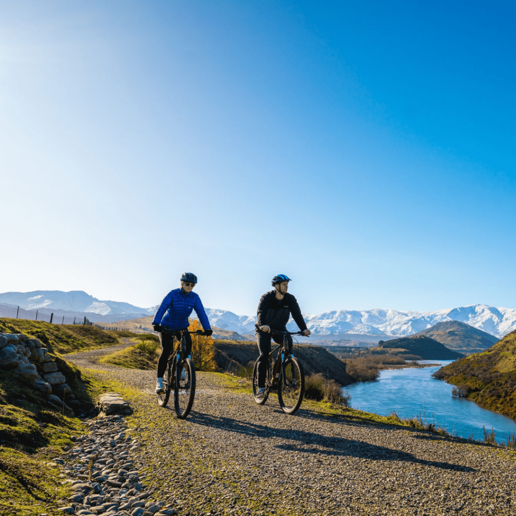 Arrowtown Bike Tour riders crossing a wooden bridge